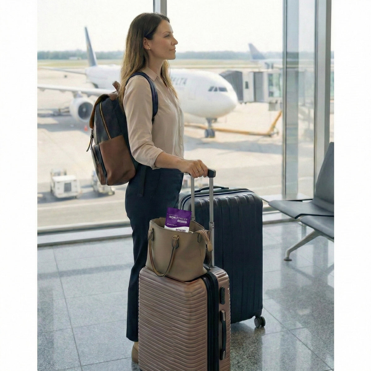 Woman waiting at an airport gate with luggage and a tote bag holding Go Wise Iron Powder, highlighting a travel-friendly gentle iron supplement and iron powder supplement designed for convenient daily use, energy support, and fatigue support on the go.